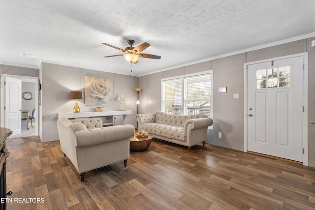 living room with dark wood-type flooring, ceiling fan, and plenty of natural light