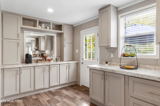 kitchen featuring gray cabinets, light wood-type flooring, and plenty of natural light