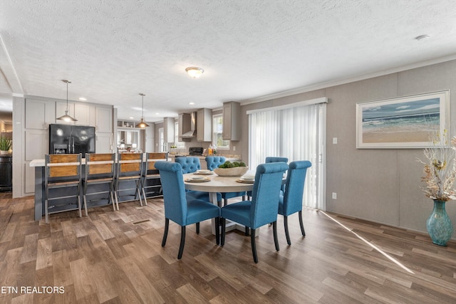 dining room featuring crown molding, a textured ceiling, and dark wood-type flooring