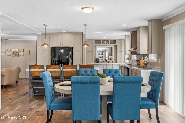 dining area featuring hardwood / wood-style floors and a textured ceiling