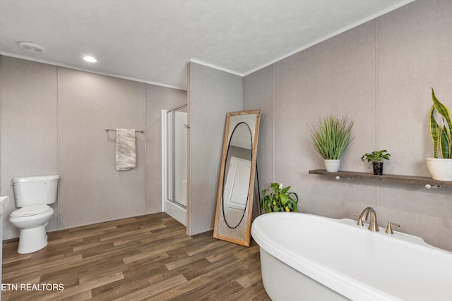 bathroom featuring ornamental molding, plus walk in shower, and wood-type flooring