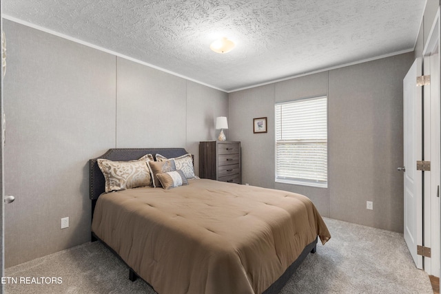 bedroom featuring crown molding, a textured ceiling, and carpet floors