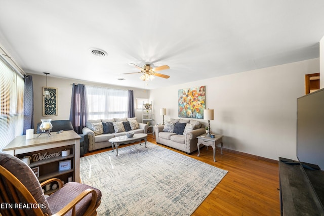 living room featuring hardwood / wood-style flooring and ceiling fan