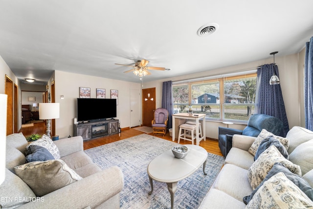 living room with wood-type flooring and ceiling fan