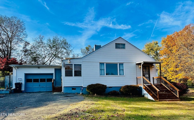 view of front of home with a garage and a front lawn