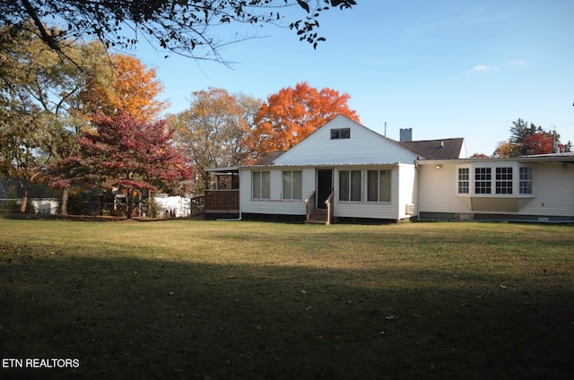 back of property featuring a yard