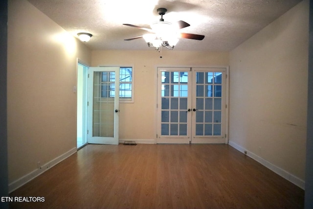 empty room with french doors, wood-type flooring, a textured ceiling, and ceiling fan