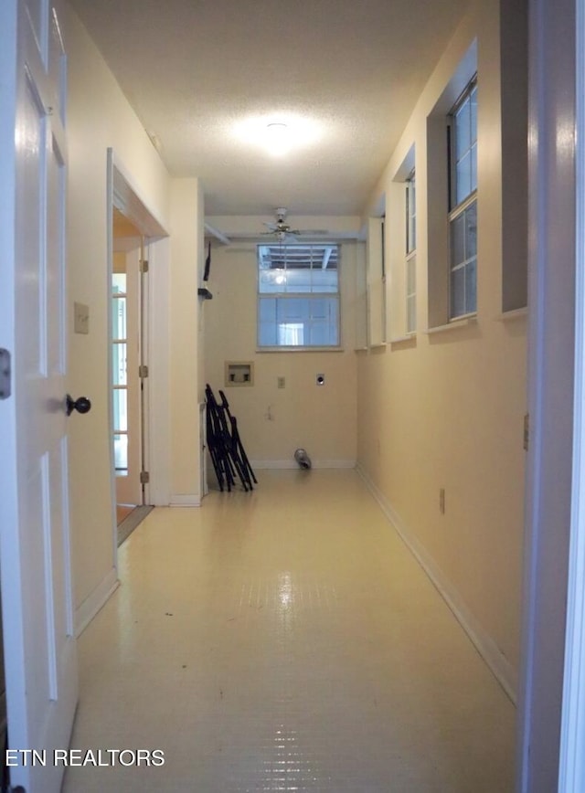 hallway featuring a textured ceiling