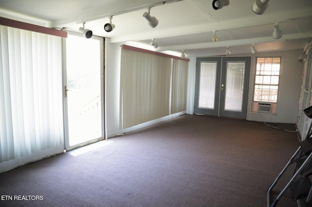 carpeted spare room featuring french doors, cooling unit, and rail lighting