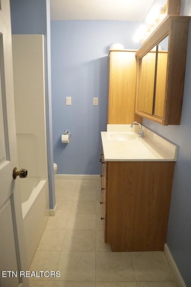 bathroom featuring vanity, toilet, and tile patterned flooring