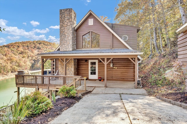 view of front of house with covered porch and a water and mountain view