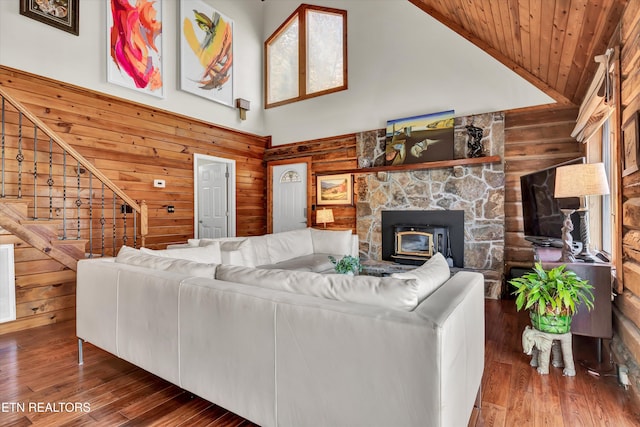 living room with wood ceiling, wood walls, high vaulted ceiling, and dark hardwood / wood-style flooring