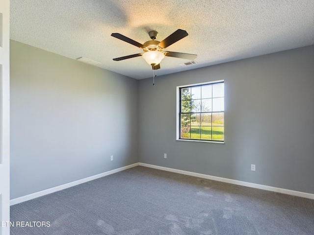 unfurnished room with a textured ceiling, carpet floors, and ceiling fan