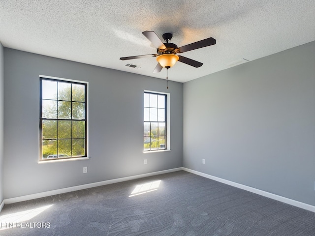 carpeted empty room with a textured ceiling and ceiling fan