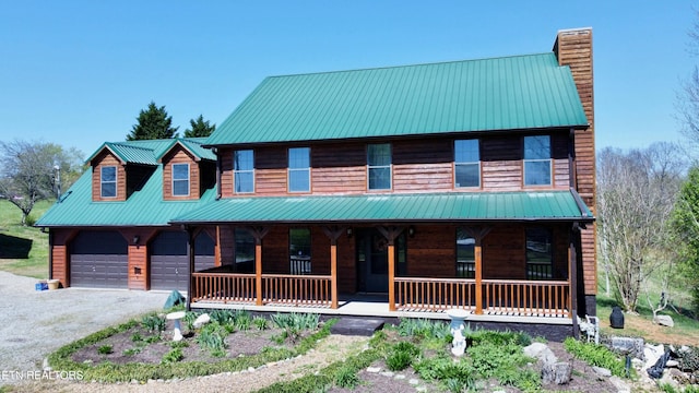 view of front of property with covered porch and a garage