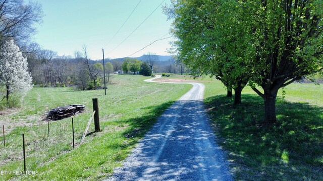 view of home's community featuring a yard and a rural view