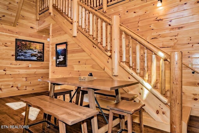 dining area featuring wood walls and hardwood / wood-style flooring