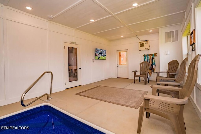 interior space featuring a wall unit AC and concrete flooring