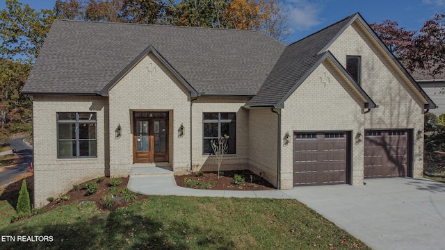 french country inspired facade featuring a garage