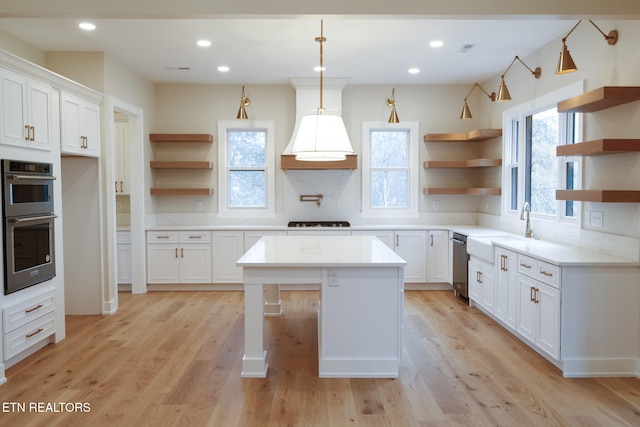 kitchen featuring white cabinets, a healthy amount of sunlight, and a kitchen island