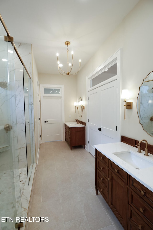 bathroom with a chandelier, vanity, tile patterned floors, and a shower with door