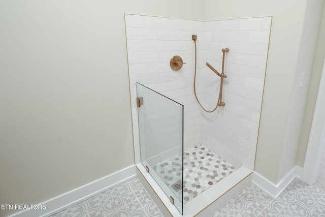 bathroom featuring tile patterned floors and tiled shower