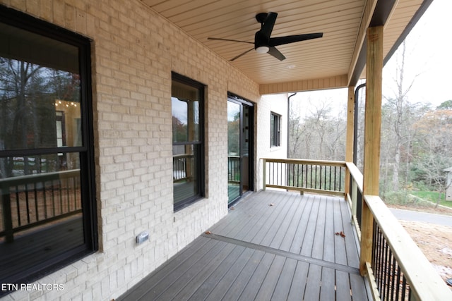 wooden terrace featuring ceiling fan