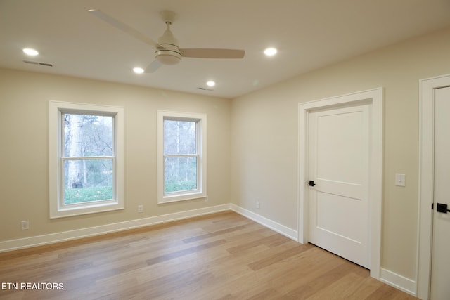 empty room featuring ceiling fan and light hardwood / wood-style floors