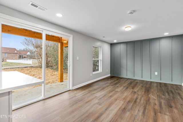 empty room with dark hardwood / wood-style flooring