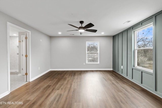 empty room featuring ceiling fan and hardwood / wood-style flooring