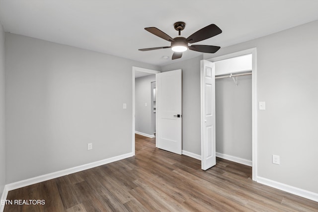 unfurnished bedroom with ceiling fan, wood-type flooring, and a closet