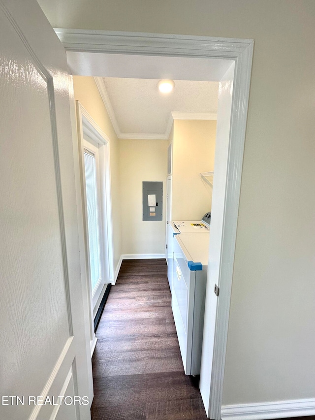 laundry area with electric panel, dark wood-type flooring, washer and clothes dryer, and crown molding