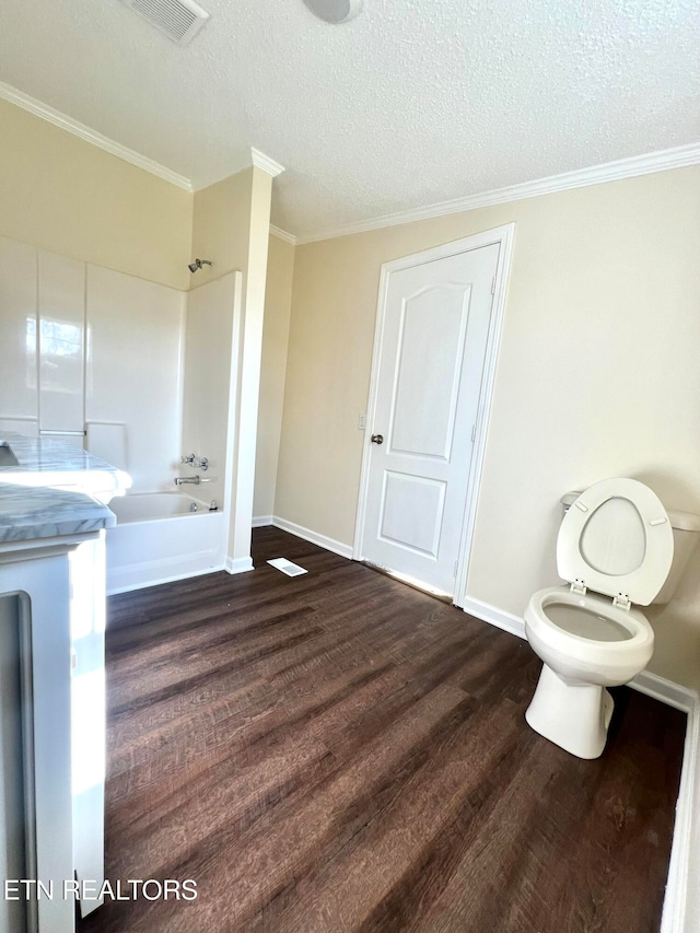 bathroom featuring toilet, washtub / shower combination, hardwood / wood-style flooring, and ornamental molding