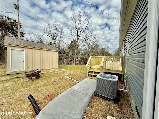 view of yard with an outbuilding, a storage shed, a deck, and cooling unit