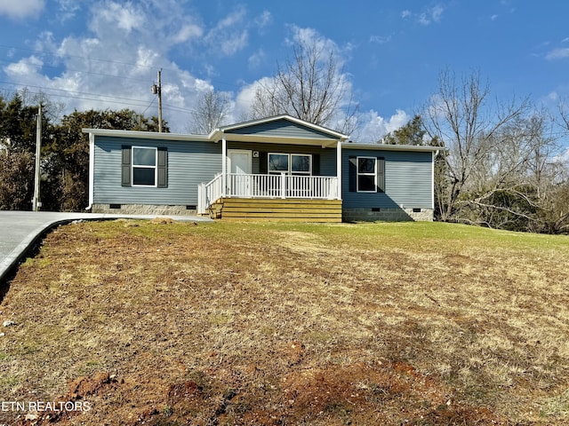 view of front of property featuring covered porch, a front lawn, and crawl space