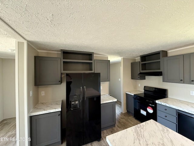 kitchen with black appliances, open shelves, light wood-style floors, and gray cabinetry