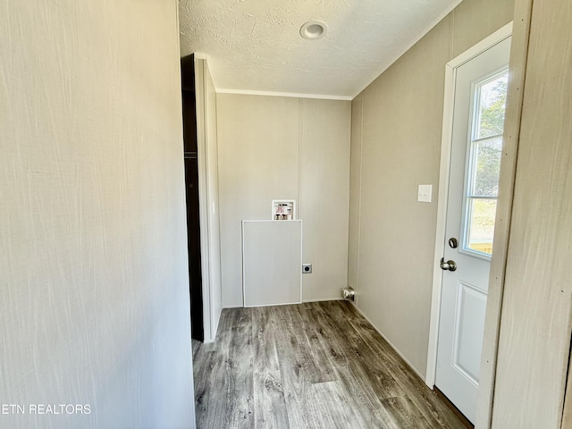 laundry room featuring a textured ceiling, laundry area, wood finished floors, and hookup for an electric dryer