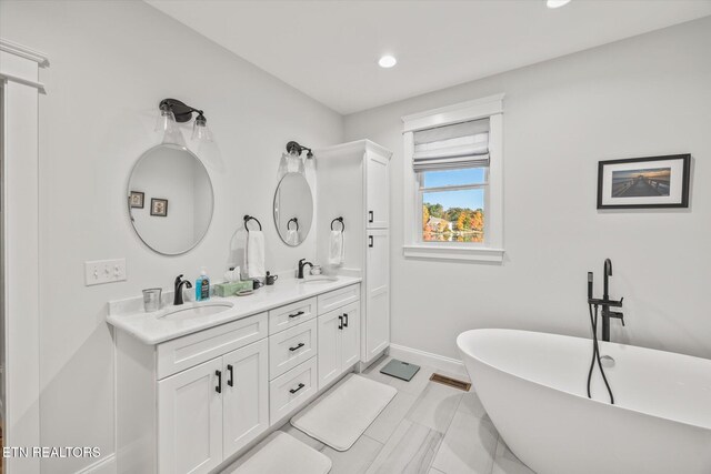 bathroom with vanity and a bathtub