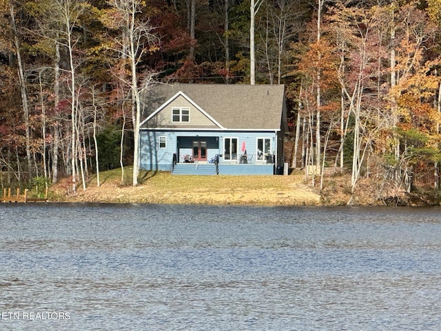 view of outbuilding with a porch and a water view