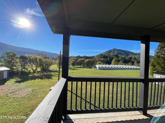 deck featuring a yard and a mountain view