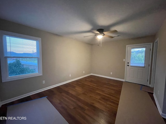 entryway featuring dark wood-type flooring and ceiling fan