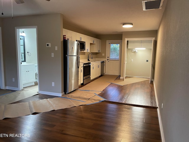 kitchen with white cabinets, ceiling fan, light wood-type flooring, sink, and stainless steel appliances