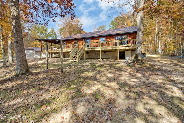 rear view of house with a wooden deck