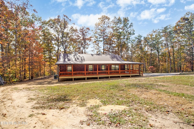 back of house featuring a wooden deck and a lawn