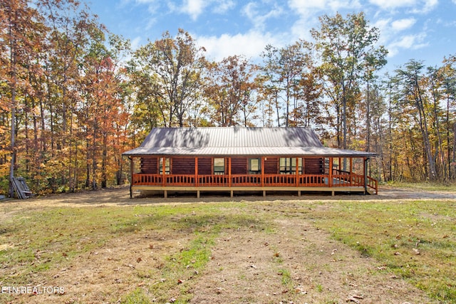 rear view of property with a yard