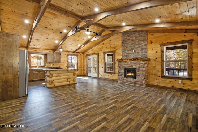 unfurnished living room with wooden walls, wood ceiling, and dark hardwood / wood-style flooring