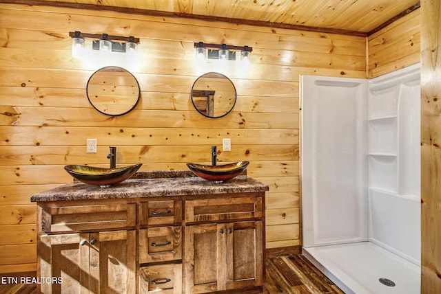 bathroom featuring vanity, wood ceiling, wood walls, and hardwood / wood-style flooring