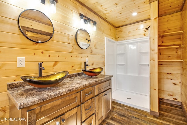 bathroom featuring vanity, wood walls, hardwood / wood-style floors, and wooden ceiling