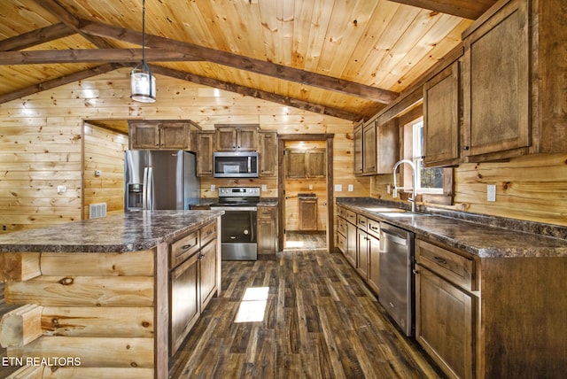 kitchen with dark hardwood / wood-style floors, lofted ceiling with beams, stainless steel appliances, and sink