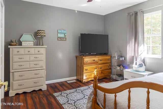 bedroom with ceiling fan and dark hardwood / wood-style floors